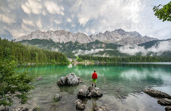 Young man standing on a rock on the shore