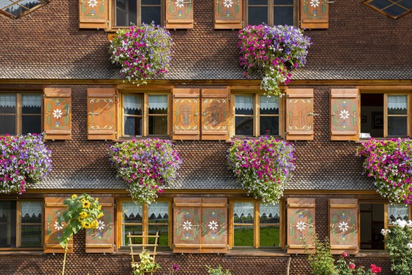 Facade of a Bregenzerwald house with flower decorations