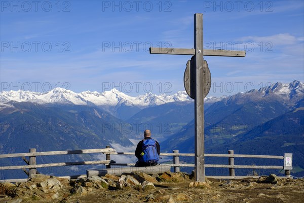 Hiker at the summit cross