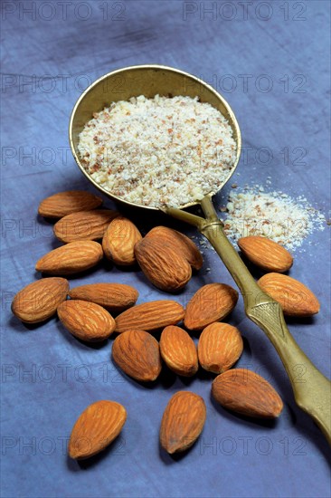 Ground almonds in brass ladle