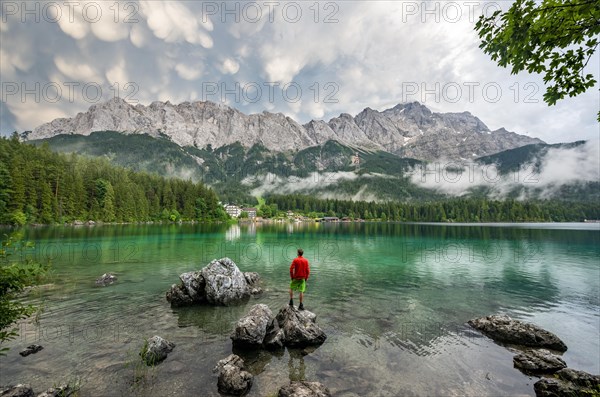 Young man standing on a rock on the shore