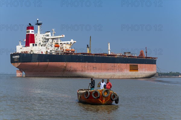 Little boat under a Huge container ship ready to break up