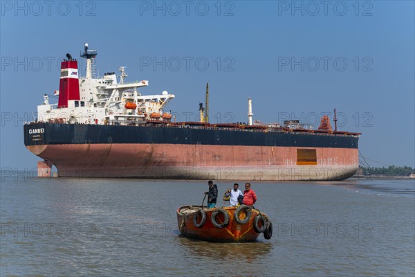 Little boat under a Huge container ship ready to break up