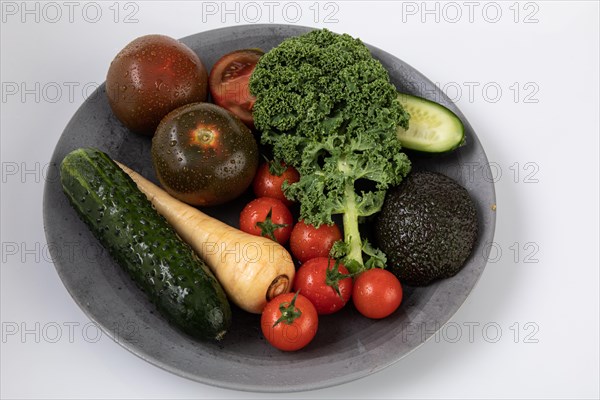 Fresh garden vegetables with water drops on a plate