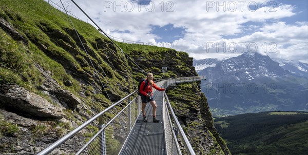 Hiker on a secured hiking trail on the slope