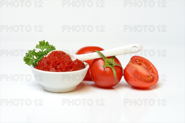 Tomato paste in bowl and spoon