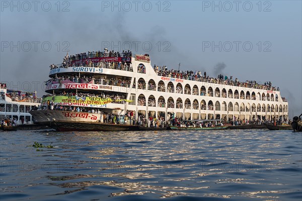 Overloaded passenger ferry with pilgrims on the Dhaka river