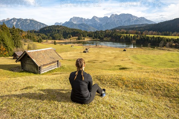 Young woman sitting in the meadow