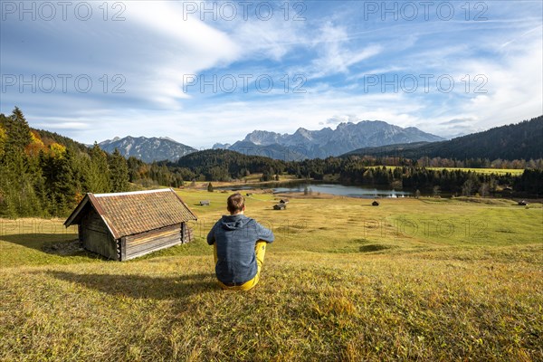 Young man sitting in the meadow