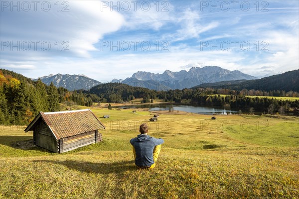 Young man sitting in the meadow
