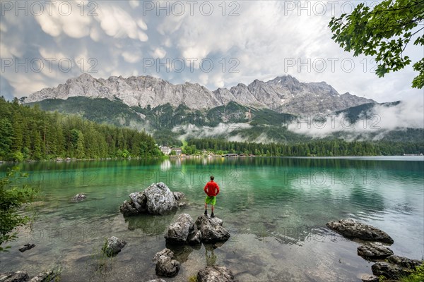 Young man standing on a rock on the shore