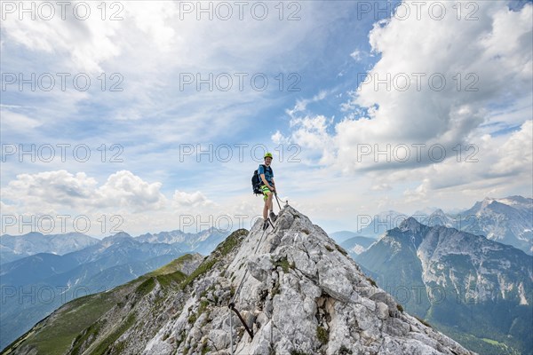 Mountaineer on a ridge on a secured fixed rope route