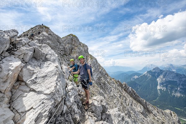 Mountaineers climbing on a secured fixed rope route