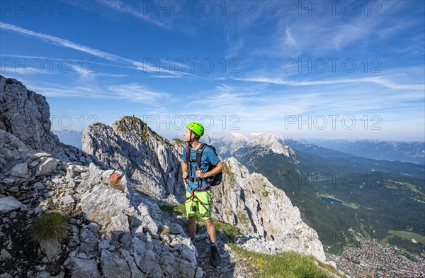 Mountaineer climbs on a secured fixed rope route