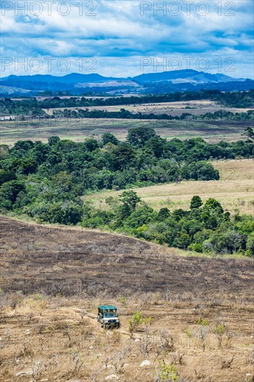 Tourist jeep driving through the savannah of the Unesco world heritage sight