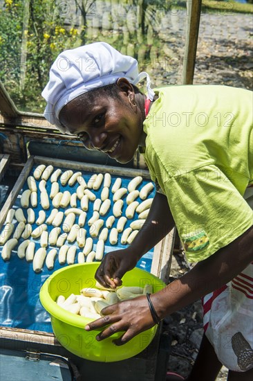 Woman preparing bananas to dry