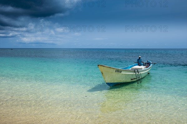 Little motorboat in the turquoise waters of Banana beach