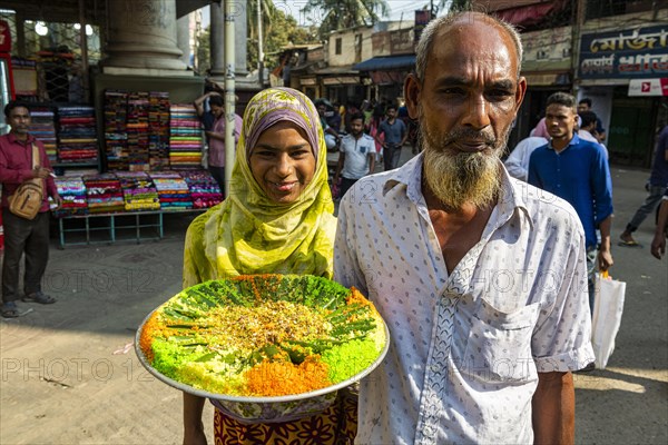 Man holding a colourful plate of food