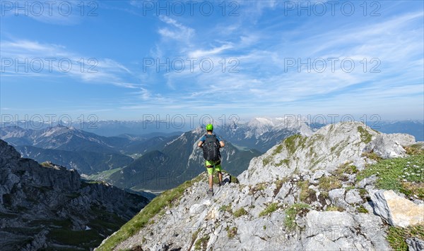 Mountaineer climbs on a secured fixed rope route