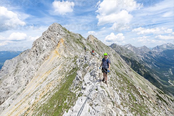 Mountaineer on a ridge on a secured fixed rope route