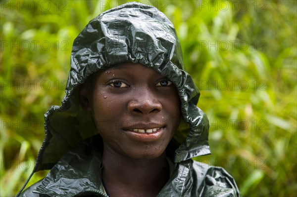 Pretty girl wearing a raincape smiling