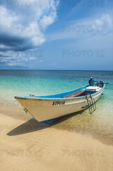 Little motorboat in the turquoise waters of Banana beach