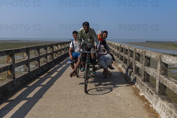 Rickshaw driver with several people on a Long pier in the Chittagong Ship Breaking Yard