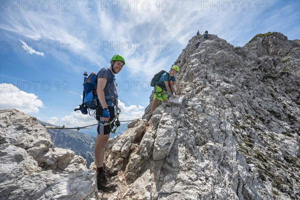 Mountaineer on a ridge on a secured fixed rope route