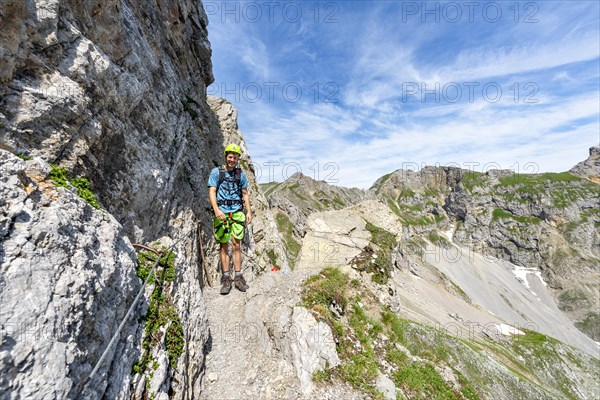 Mountaineer on a secured fixed rope route