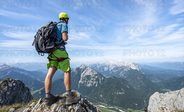 Mountaineer on a ridge on a secured fixed rope route