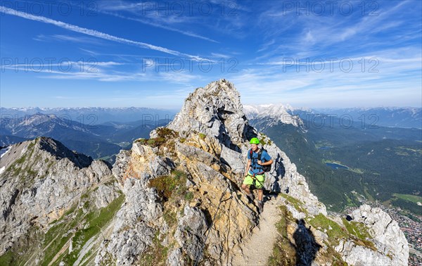 Mountaineer on a ridge on a secured via ferrata