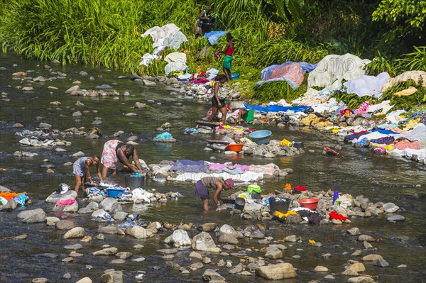 Women washing their clothes in a river at the east coast of Sao Tome