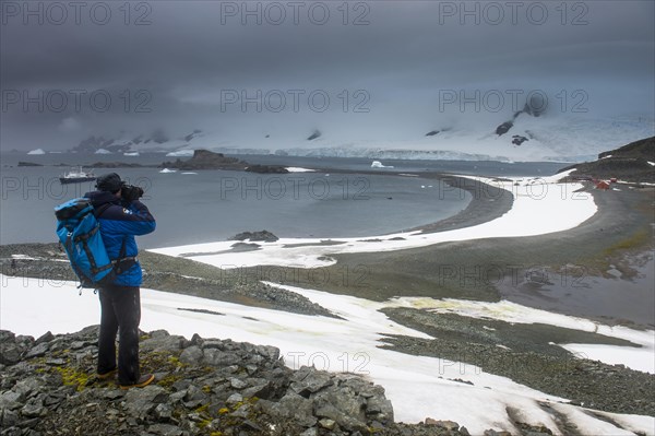 Tourist photographing from an overlook over Half moon island