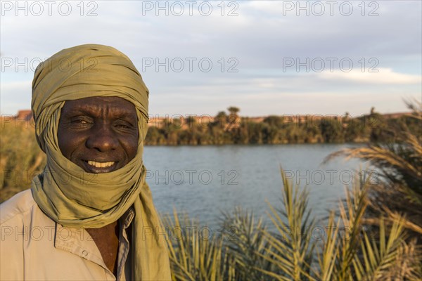 Beduin at the shore of Ounianga kebir part of the the Unesco sight Ounianga lakes