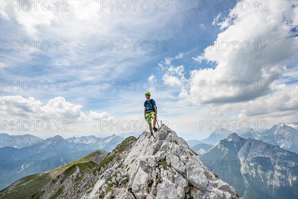 Mountaineer on a ridge on a secured fixed rope route