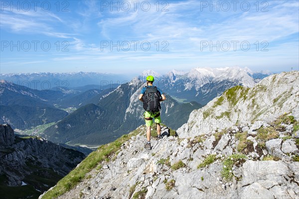 Mountaineer climbs on a secured fixed rope route