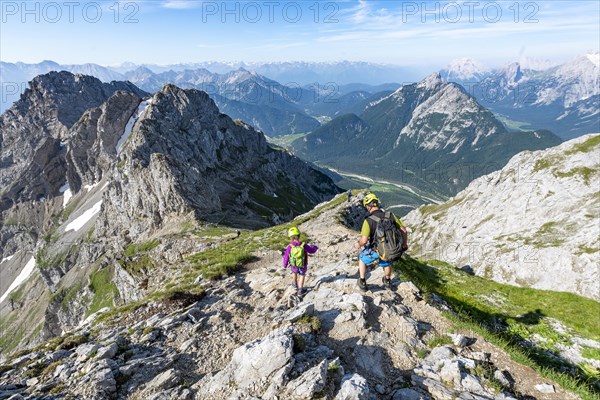 Mountaineers climbing on a secured via ferrata