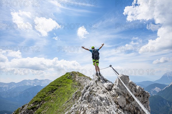 Mountaineer on a ridge on a secured fixed rope route