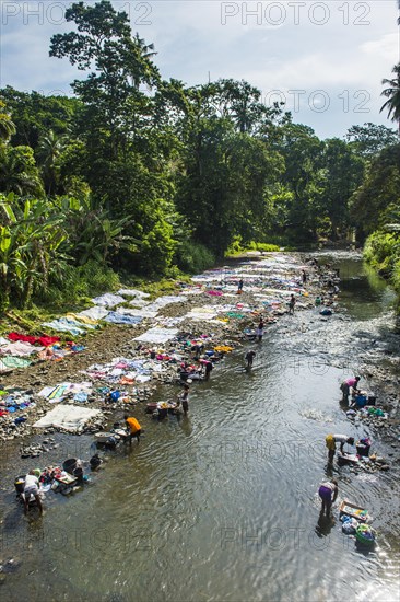 Women washing their clothes in a river at the east coast of Sao Tome