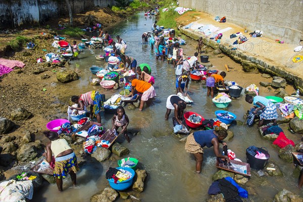 Women washing clothes in a river bed