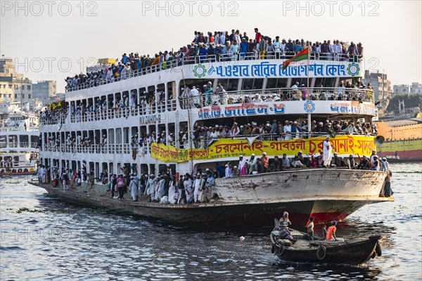 Overloaded passenger ferry with pilgrims on the Dhaka river