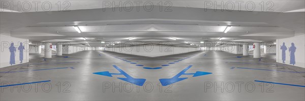 Photomontage of an empty underground car park with blue arrows on the ground