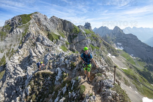 Mountaineer on a ridge on a secured fixed rope route