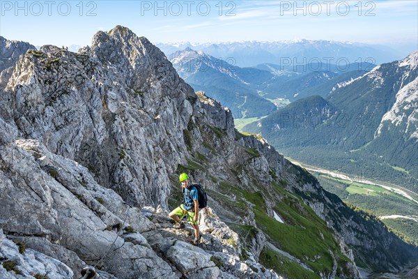 Mountaineer climbs on a secured fixed rope route