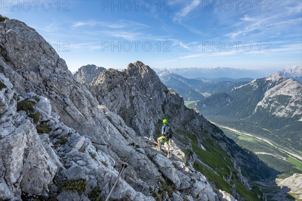 Mountaineer climbs on a secured fixed rope route