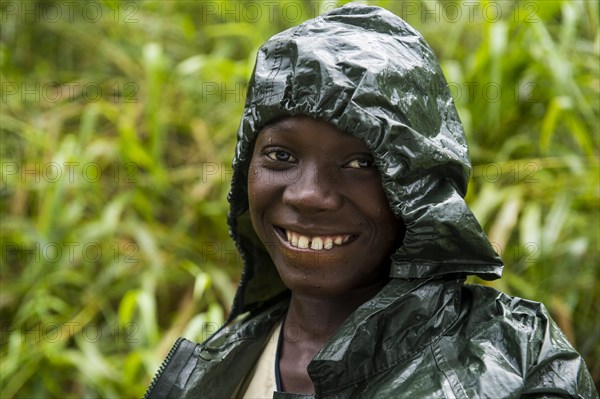 Pretty girl wearing a raincape smiling