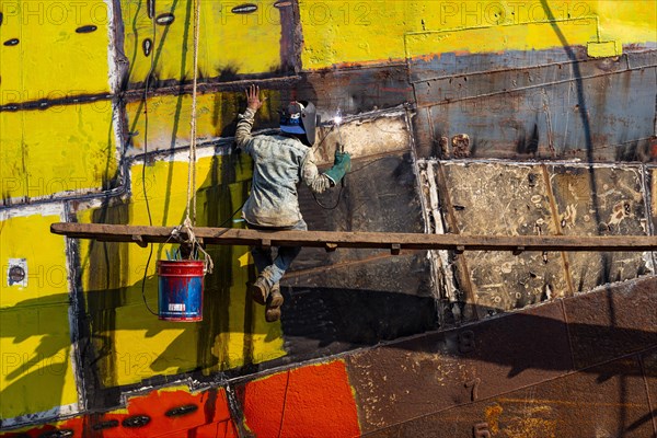 Man welding on a ship