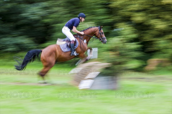 Rider over jumps obstacle with horse
