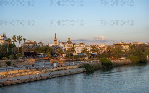 Waterfront Muelle de la sal at the river Rio Guadalquivir with Monumento a la Tolerancia