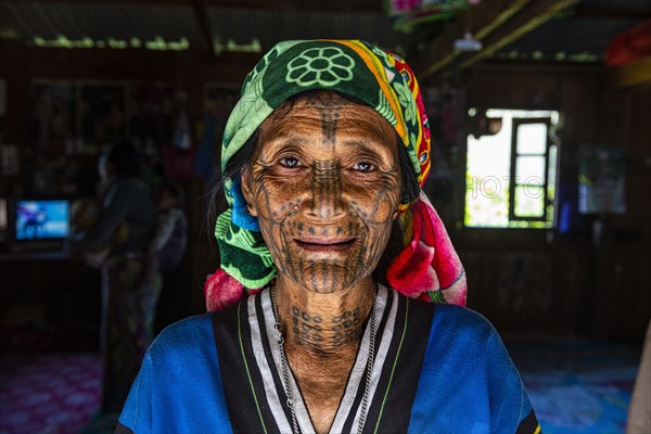 Chin woman with spiderweb tattoo